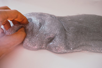 glitter slime transparent flexible viscous. game for children. antistress. hand shakes . beautiful background