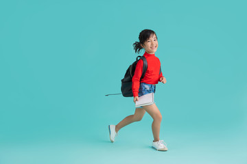 Fototapeta na wymiar Asian schoolgirl Walk to school . In the background studio