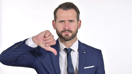 Portrait of Disappointed Young Businessman showing Thumbs Down, White Background