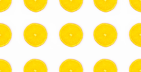 Pattern with colorful orange isolated on white background top view. Fruit pattern ornament. Healthy organic tropical fruit. Summer, vacation copcept. Web banner template. Stock photo.