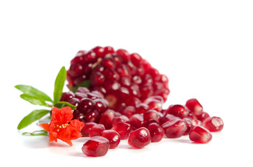 Parts of a pomegranate with pomegranate seeds and leaves, flowers isolated on white background
