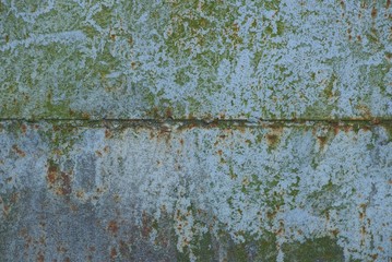 gray green metal texture from old shabby iron wall in rust with a seam