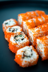 Japanese food. Sushi. Philadelphia roll with fresh salmon, cucumber, avocado, cream cheese, tobiko caviar. Sushi menu. Top view