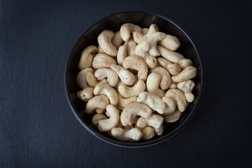 A studio photograph of a bowl of cashew nuts