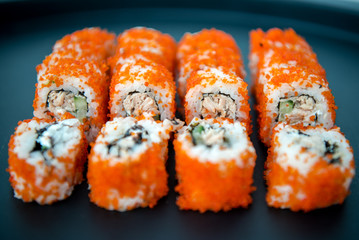Japanese food. Sushi. Philadelphia roll with fresh salmon, cucumber, avocado, cream cheese, tobiko caviar. Sushi menu. Top view