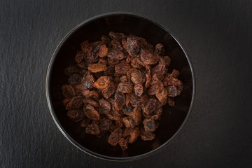A studio photograph of a bowl of sultanas