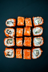 Japanese food. Sushi. Philadelphia roll with fresh salmon, cucumber, avocado, cream cheese, tobiko...