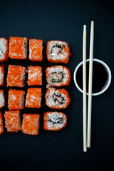 Japanese food. Sushi. Philadelphia roll with fresh salmon, cucumber, avocado, cream cheese, tobiko caviar. Sushi menu. Top view