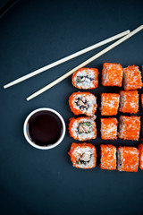 Japanese food. Sushi. Philadelphia roll with fresh salmon, cucumber, avocado, cream cheese, tobiko caviar. Sushi menu. Top view