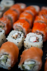 Japanese food. Sushi. Philadelphia roll with fresh salmon, cucumber, avocado, cream cheese, tobiko caviar. Sushi menu. Top view