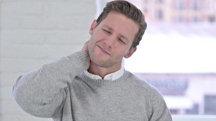 Obraz premium Portrait of Tired Creative Young Man having Neck Pain