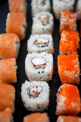 Japanese food. Sushi. Philadelphia roll with fresh salmon, cucumber, avocado, cream cheese, tobiko caviar. Sushi menu. Top view