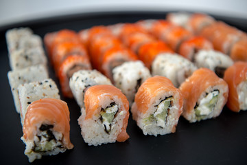 Japanese food. Sushi. Philadelphia roll with fresh salmon, cucumber, avocado, cream cheese, tobiko caviar. Sushi menu. Top view