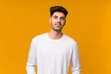Fototapeta premium Young man over isolated orange background laughing