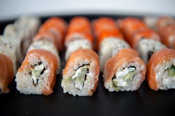 Japanese food. Sushi. Philadelphia roll with fresh salmon, cucumber, avocado, cream cheese, tobiko caviar. Sushi menu. Top view