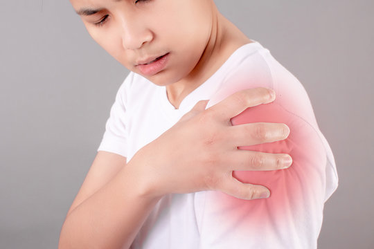 Closeup pictures of Asian people wearing white shirts with shoulder pain or upper arm pain. Concept of problems with muscles.