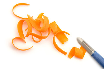 Carrot shavings and peeler knife on white background