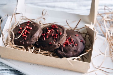 Chocolate cookies with raspberries in a gift box. Freeze-dried raspberries