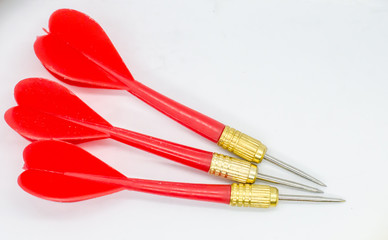 Three Red darts with golden tip pointing in the same direction.
