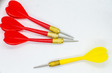 Three Red and one Yellow darts in the Opposite direction. Concept the odd one to hit the target.