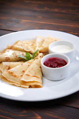 pancakes with sour cream and berry sauce