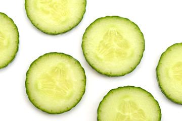 Cucumber circle slices on white background, close up