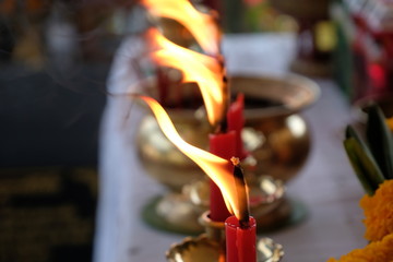 The flame from the red candle ignited to pay respect.