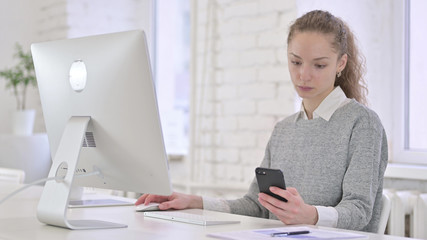 Young Latin Woman Using Smartphone for Work