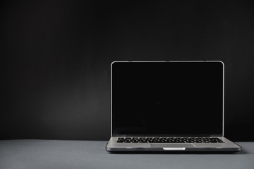 Blank screen laptop on dark grey background in minimal style. Front view social media, website,...