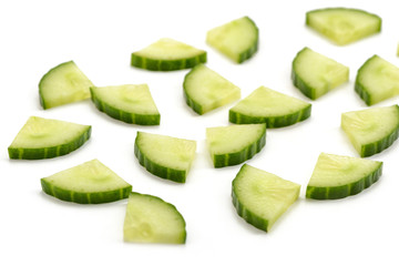Cucumber quarter slices on white background