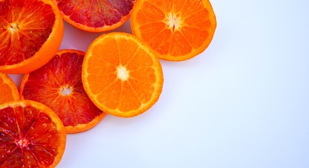 Platter of orange and mandarosa red clementines cut in half on a white platter