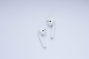 White modern wireless earphones at white background