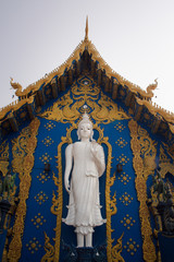 Obraz premium The white Buddha standing on .dragon shaped base at Blue temple.