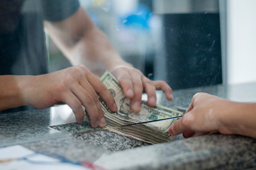 Closeup bank counter handing money