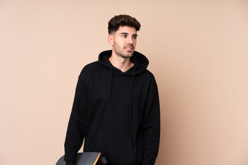 Obraz premium Young man over isolated background with a skate