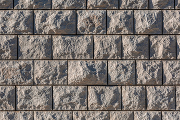 Light brown brick wall with paving stone texture