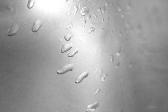 drops on a metal surface. Abstract background template can be used as a wall paper screen saver page cover