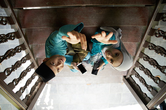 High Angle View Of Malay Clothing With Traditional Clothing Looking Up To The Camera