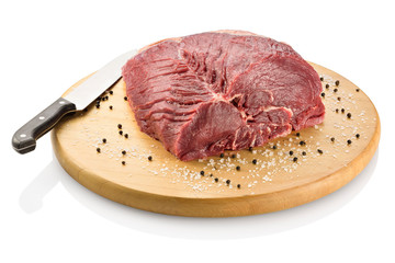 Raw rump steak, ready to be cooked. On a cutting board with black peppercorns and coarse salt,...