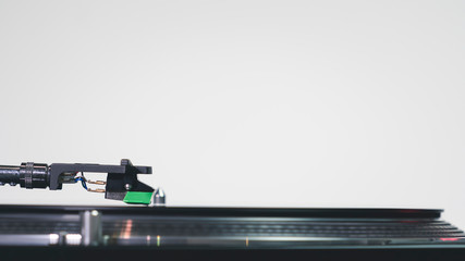 Close-up of modern turntable vinyl record player with music plate. Needle on a vinyl record.