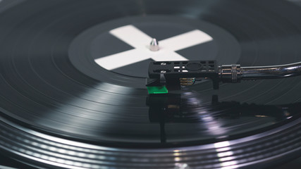 Close-up of modern turntable vinyl record player with music plate. Needle on a vinyl record.