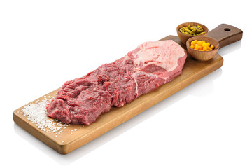 Raw filet mignon, a steak cut of beef taken from the smaller end of the tenderloin, or psoas major of the cow, ready to be cooked. On a cutting board, isolated on white background