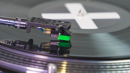Close-up of modern turntable vinyl record player with music plate. Needle on a vinyl record.