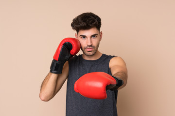 Young sport man over isolated background with boxing gloves