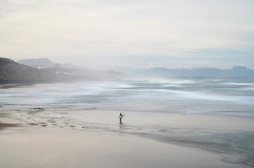 Surfer looking for the waves in the beach, Biarritz, Pyrenees Atlantiques, Aquitaine, France - obrazy, fototapety, plakaty