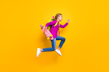 Fototapeta na wymiar Full length body size view of her she nice attractive lovely glad purposeful cheerful cheery girl jumping running isolated over bright vivid shine vibrant yellow color background