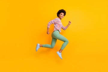 Full length profile side photo of funky dreamy cheerful afro american girl jump run hurry want black friday discount wear green good fall spring outfit isolated over shine color background