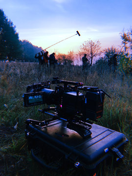 shooting a film at dawn, one camera in standby mode, the second group in force to shoot in the background