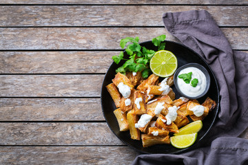 Fried yucca, yuca, cassava, manioca, mandioca with cilantro sauce