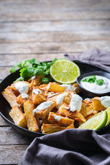 Fried yucca, yuca, cassava, manioca, mandioca with cilantro sauce